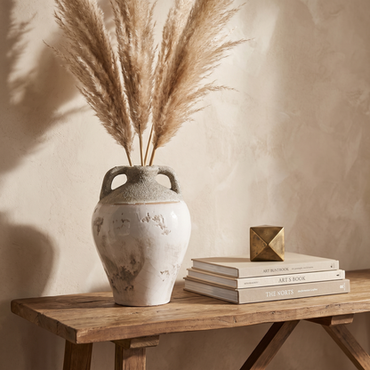 Artois whitewashed ceramic amphora vase with dried stems on a console table