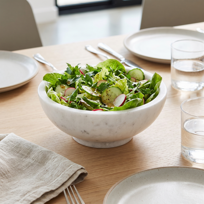 Skye bowl filled with fresh green salad on a set dining table