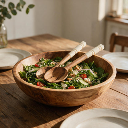 Olive wood salad servers with bone handles in a salad bowl