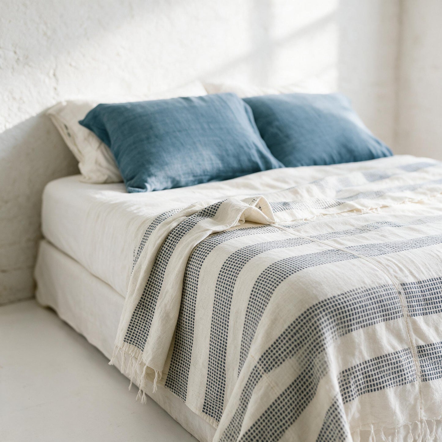 Three-panel dotted cotton blanket on a king bed