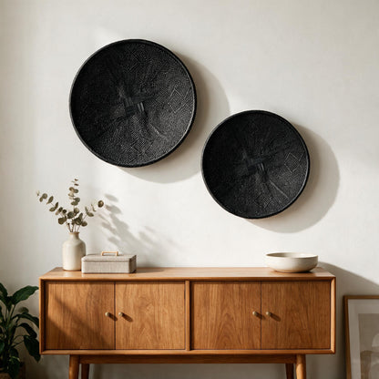 Hand-painted black Binga flat baskets, set of two, on a wall