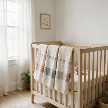 Handwoven cotton baby swaddle over a cot rail