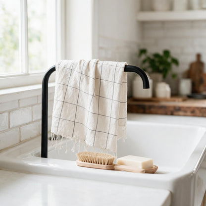 Windowpane plaid hand towel beside a sink