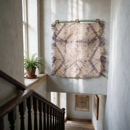 Lavender grey raffia spider web wall hanging in a stairwell